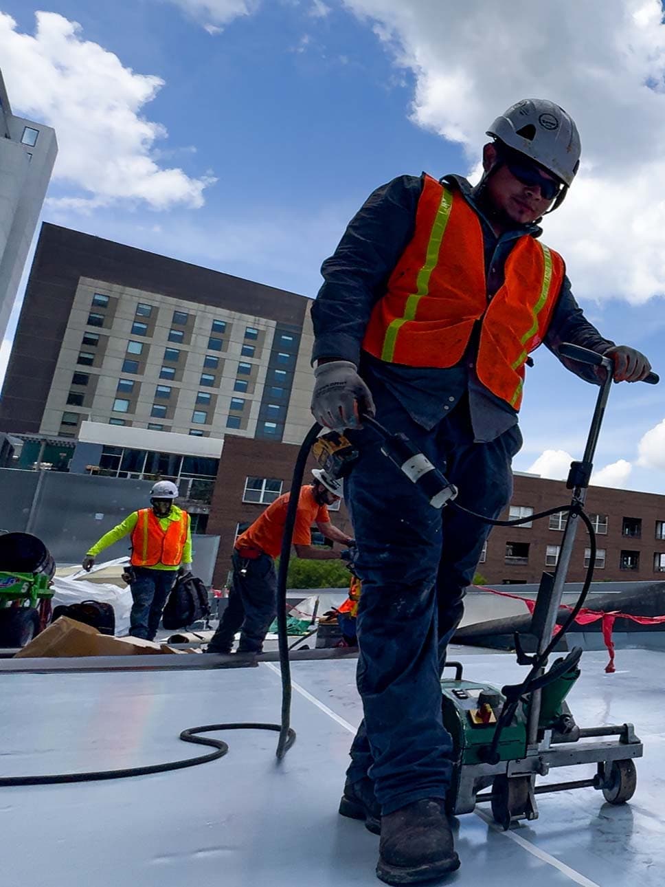 Commercial roofing professionals installing a membrane system